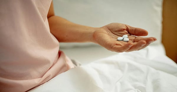 Woman Holding Pills